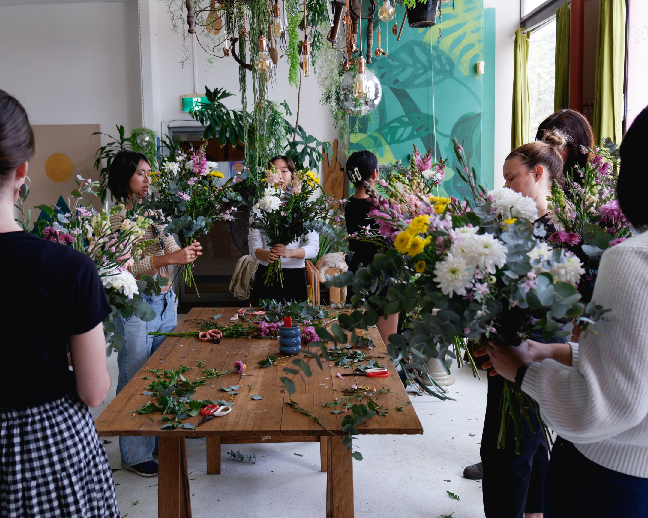 Group shot of flower workshop class, students creating their arrangements with Australian grown flowers.