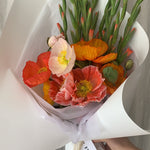 Posie of colourful poppies and mini gladioli wrapped in Florada gift wrap and silk ribbon.