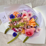 Top view of Florada floral bunch with mixed flowers as selected by florist including dahlias, ranunculus, lupins, cornflower, cosmos and carnations. 